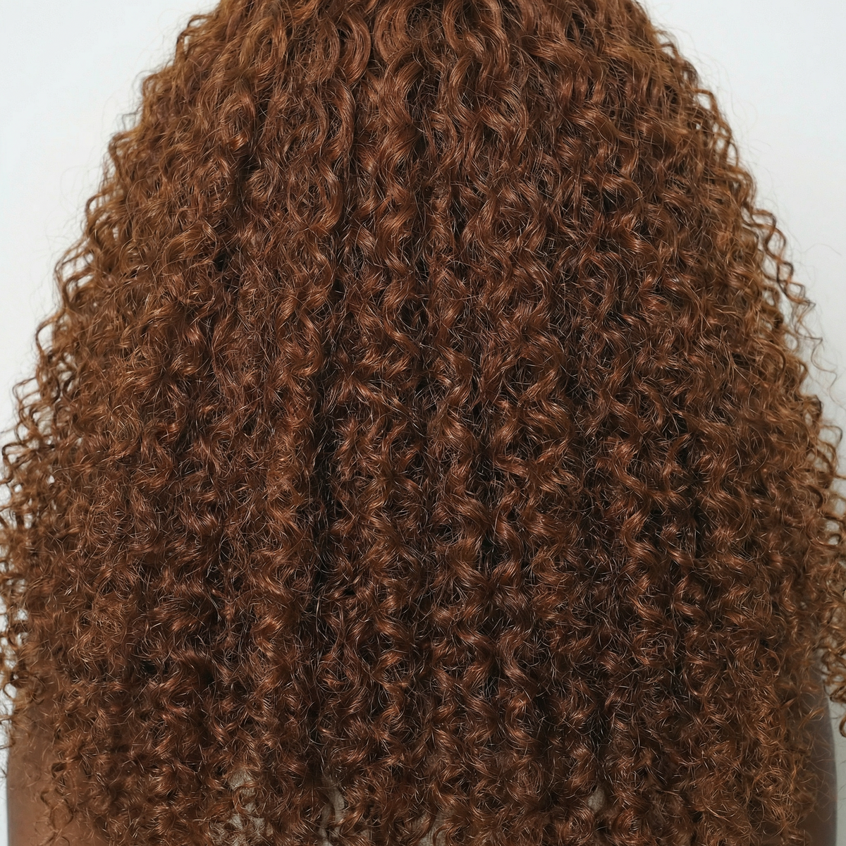 WIGZ 09 - Macro close-up of CURLY COPPER BROWN PURE-VIRGIN HAIR™ texture and shine.