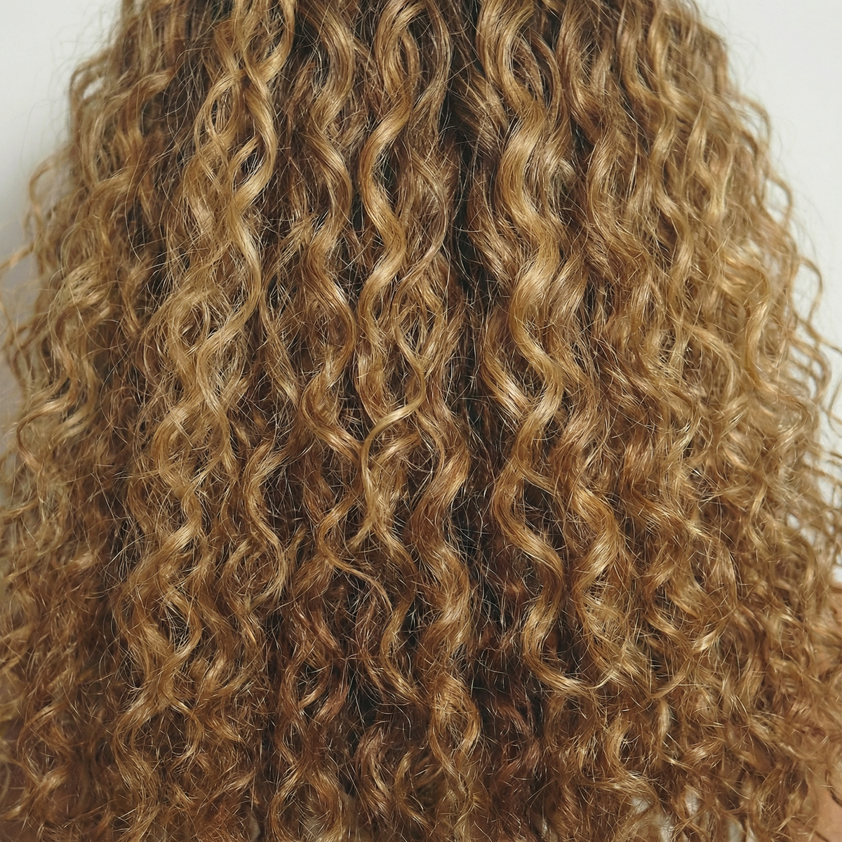 WIGZ 10 - Macro close-up of CURLY BLONDE BALAYAGE PURE-VIRGIN HAIR™ texture and shine.