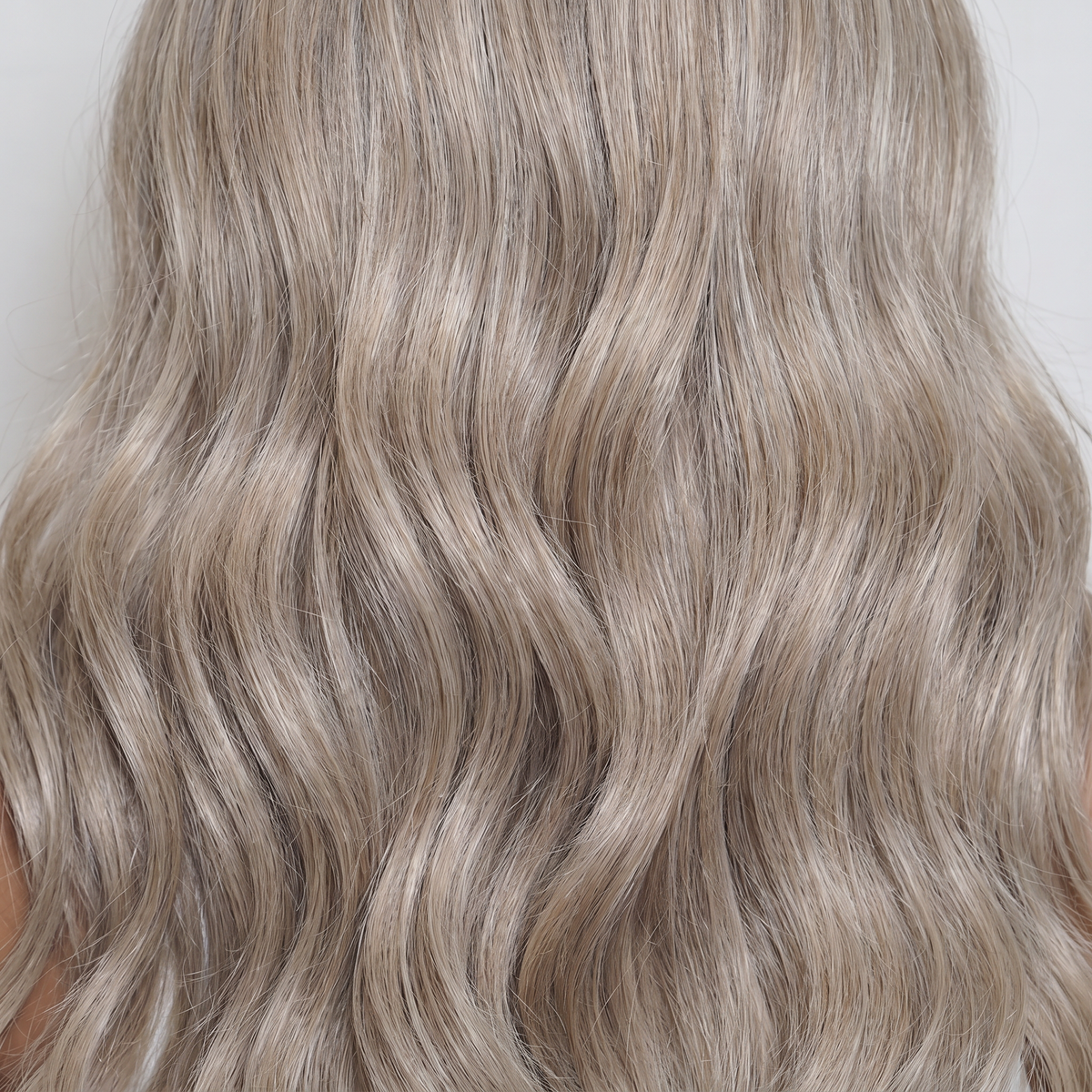 WIGZ 44 - Macro close-up of WAVY ASH BLONDE PURE-VIRGIN HAIR™ texture and shine.