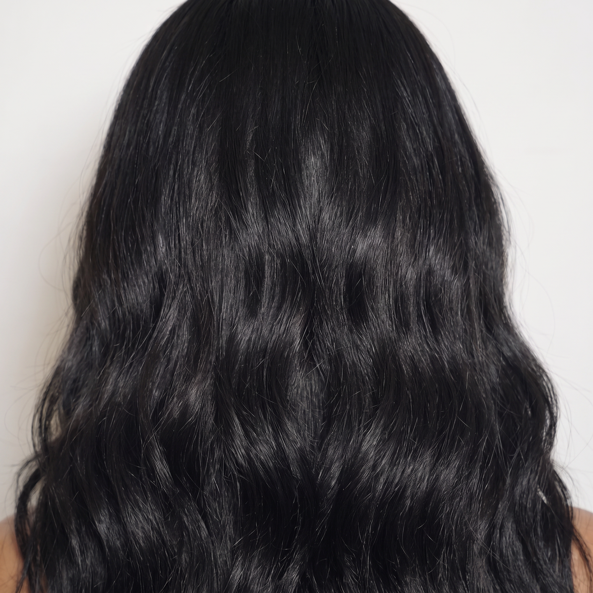 WIGZ 46 - Macro close-up of WAVY JET BLACK PURE-VIRGIN HAIR™ texture and shine.