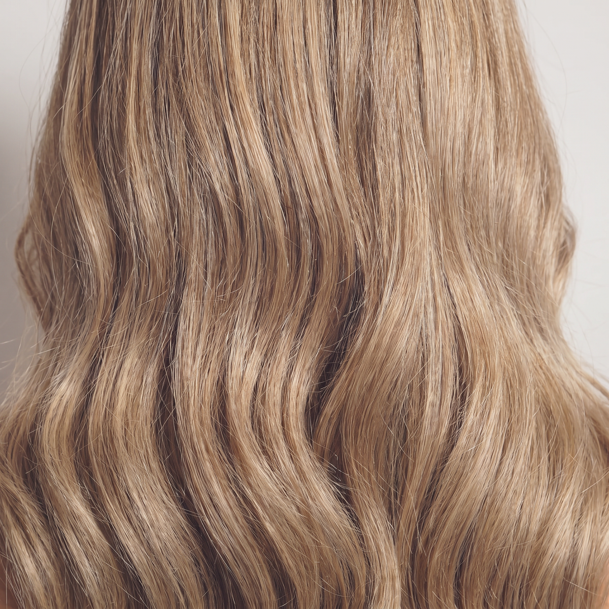 WIGZ 52 - Macro close-up of WAVY HONEY BLONDE BALAYAGE PURE-VIRGIN HAIR™ texture and shine.