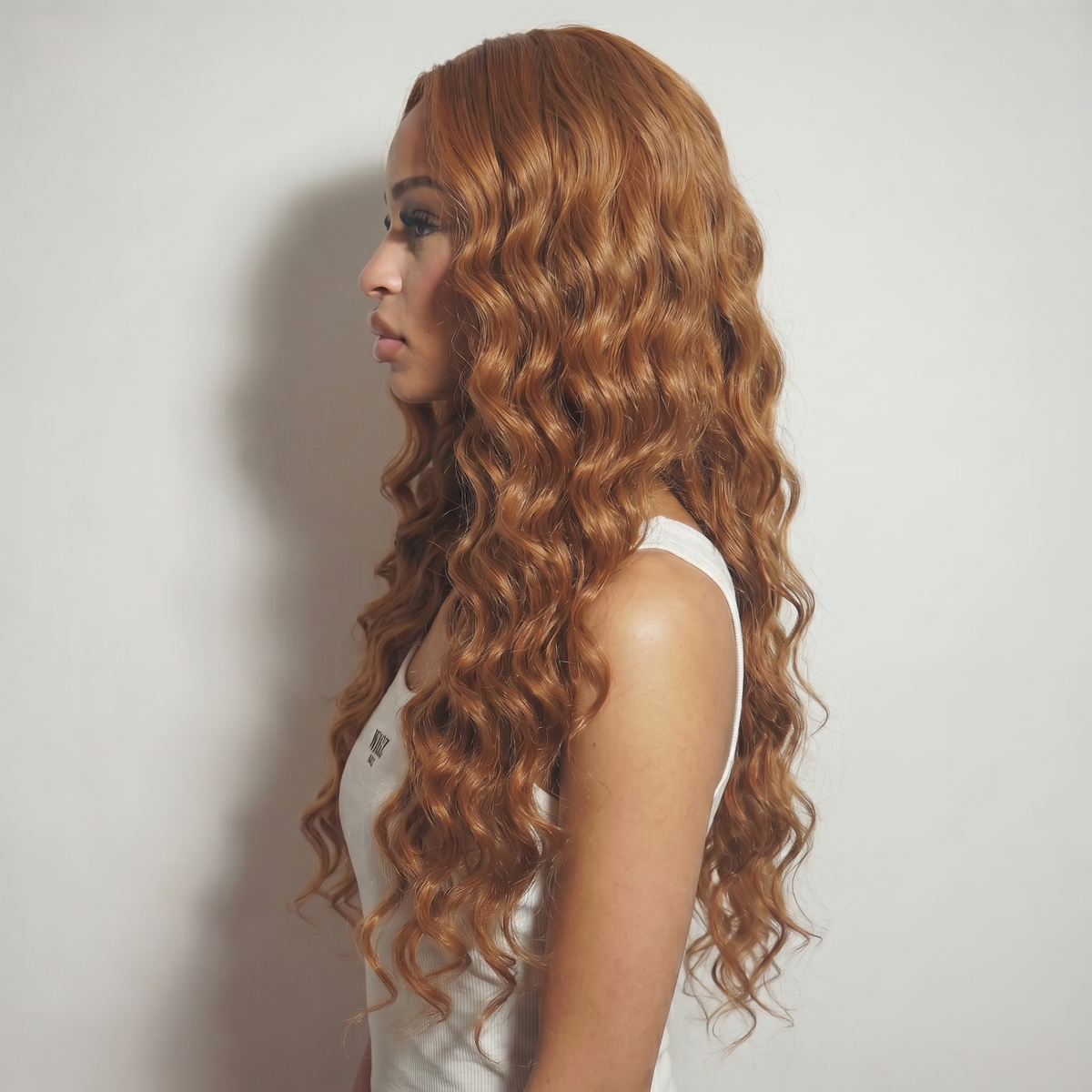 WIGZ 47 - Side profile view of layered DEEP WAVY COPPER BROWN virgin hair wig with WIGZ LAB CAP™.