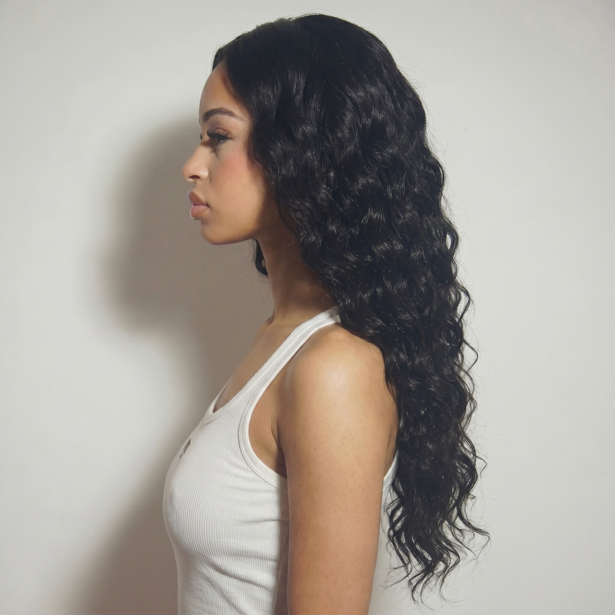 WIGZ 34 - Side profile view of layered WAVY JET BLACK virgin hair wig with WIGZ LAB CAP™.