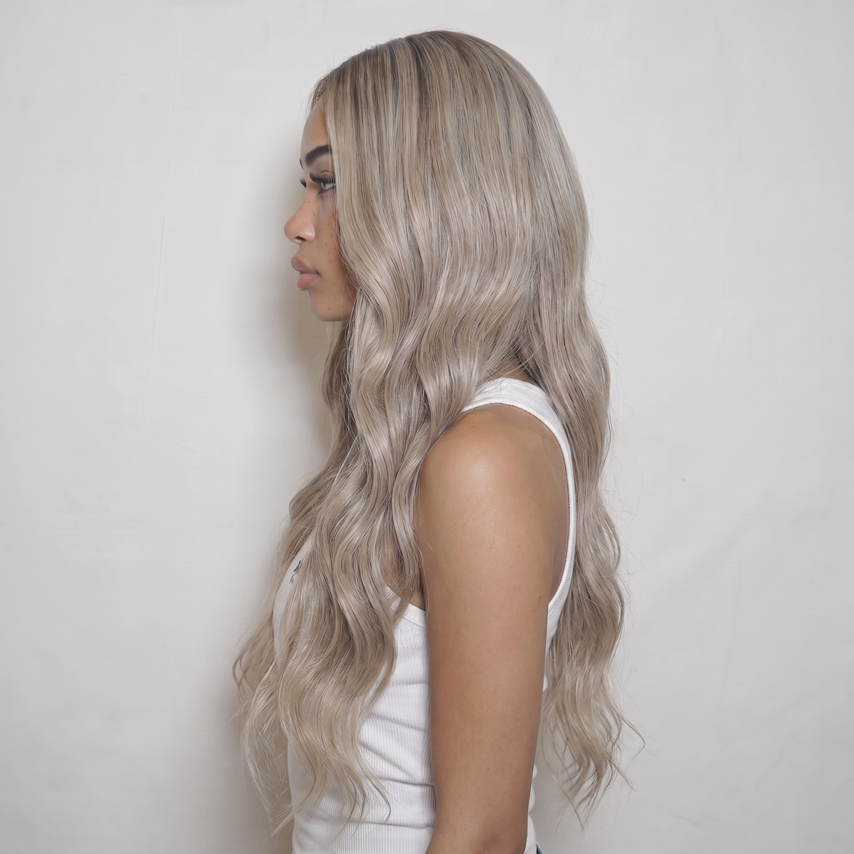 WIGZ 44 - Side profile view of layered WAVY ASH BLONDE virgin hair wig with WIGZ LAB CAP™.