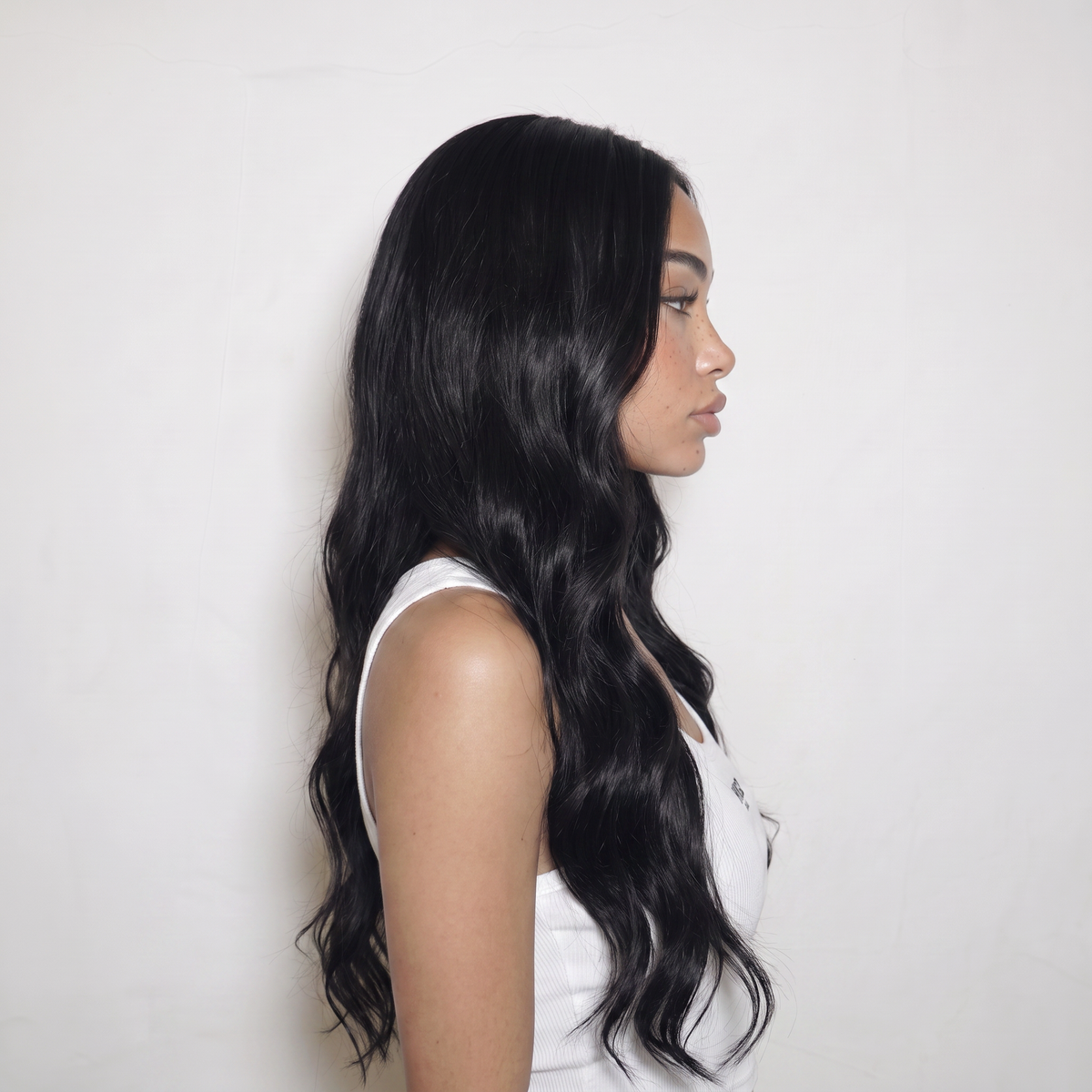 WIGZ 46 - Side profile view of layered WAVY JET BLACK virgin hair wig with WIGZ LAB CAP™.