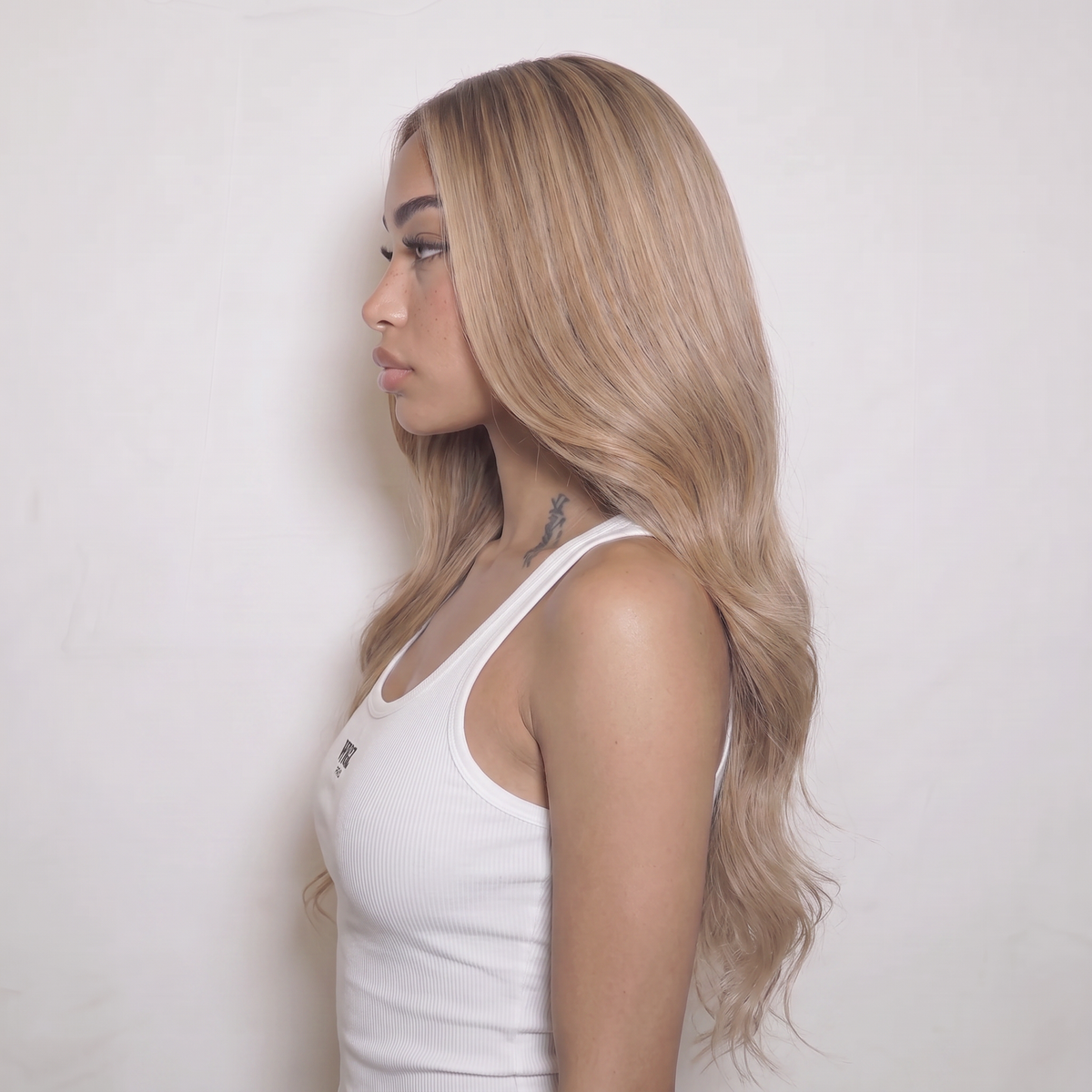 WIGZ 50 - Side profile view of layered WAVY BLONDE BALAYAGE virgin hair wig with WIGZ LAB CAP™.